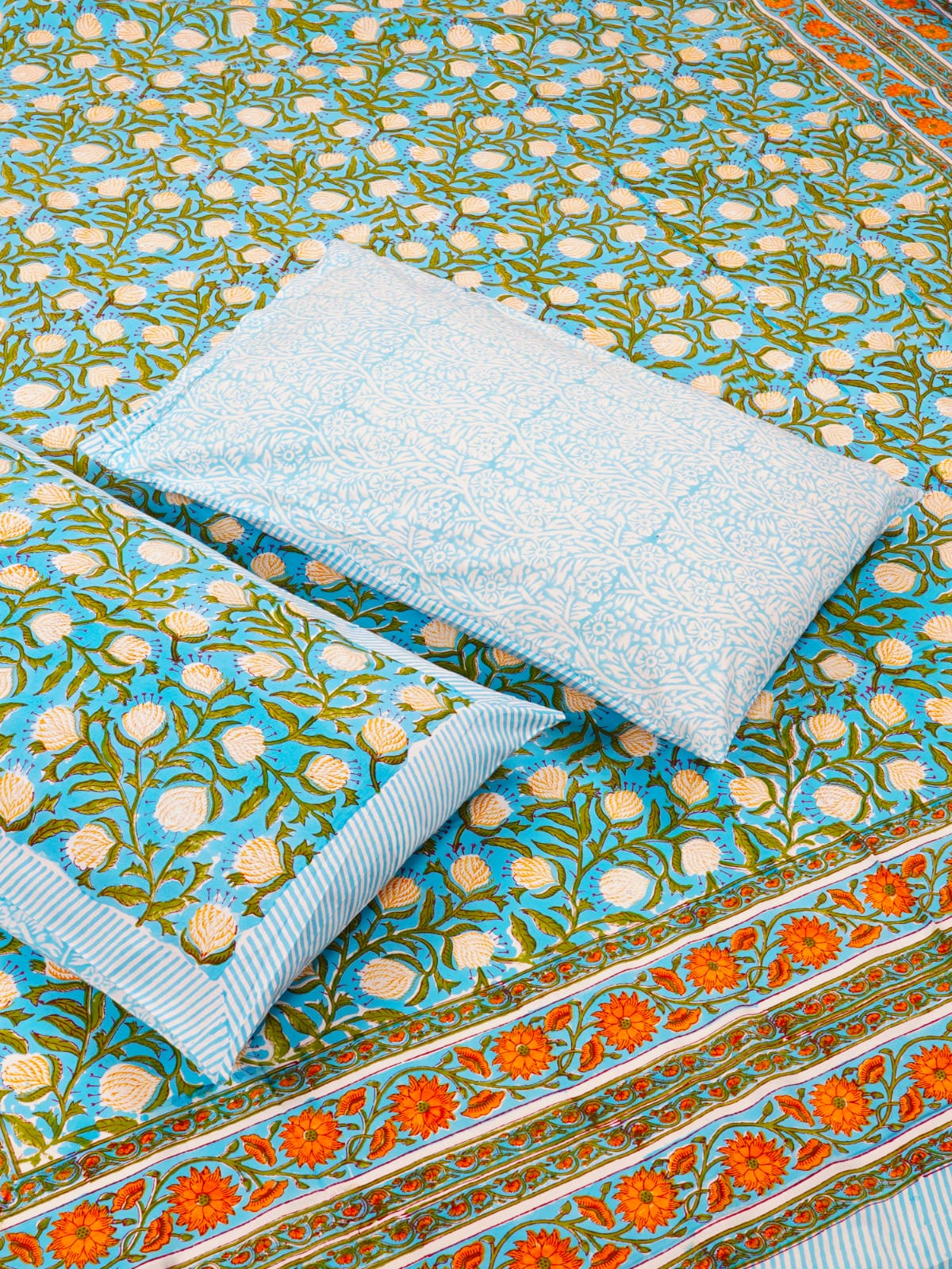 Floral patterned fabric with a white pillow on top
