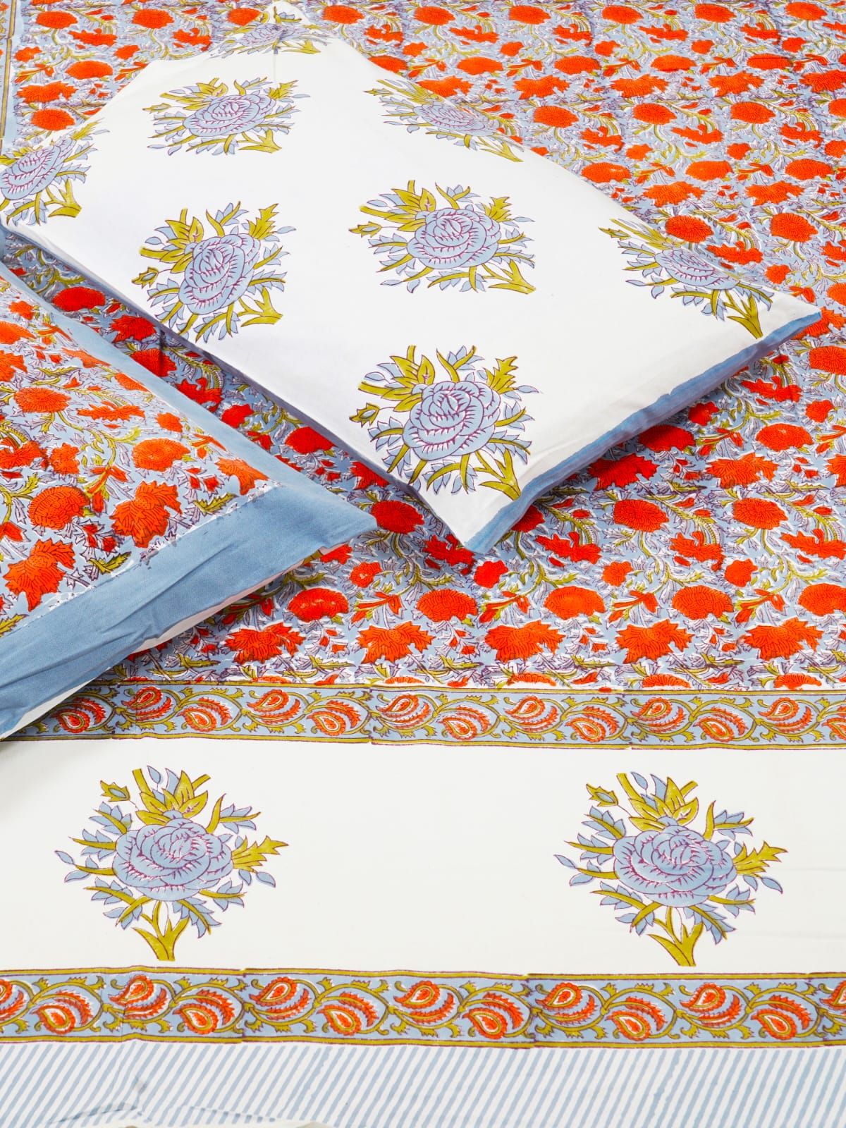 Floral patterned fabric with a white pillow on top